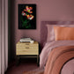 Bedroom with a bed, nightstand, and wall art of flowers.