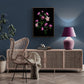  Framed dark botanical print of pink and mauve double Hellebores photographed on a black background hanging on a teal coloured wall