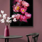Botanical print of 'Coral Sunset' Peonies framed and hung on a peach coloured wall.