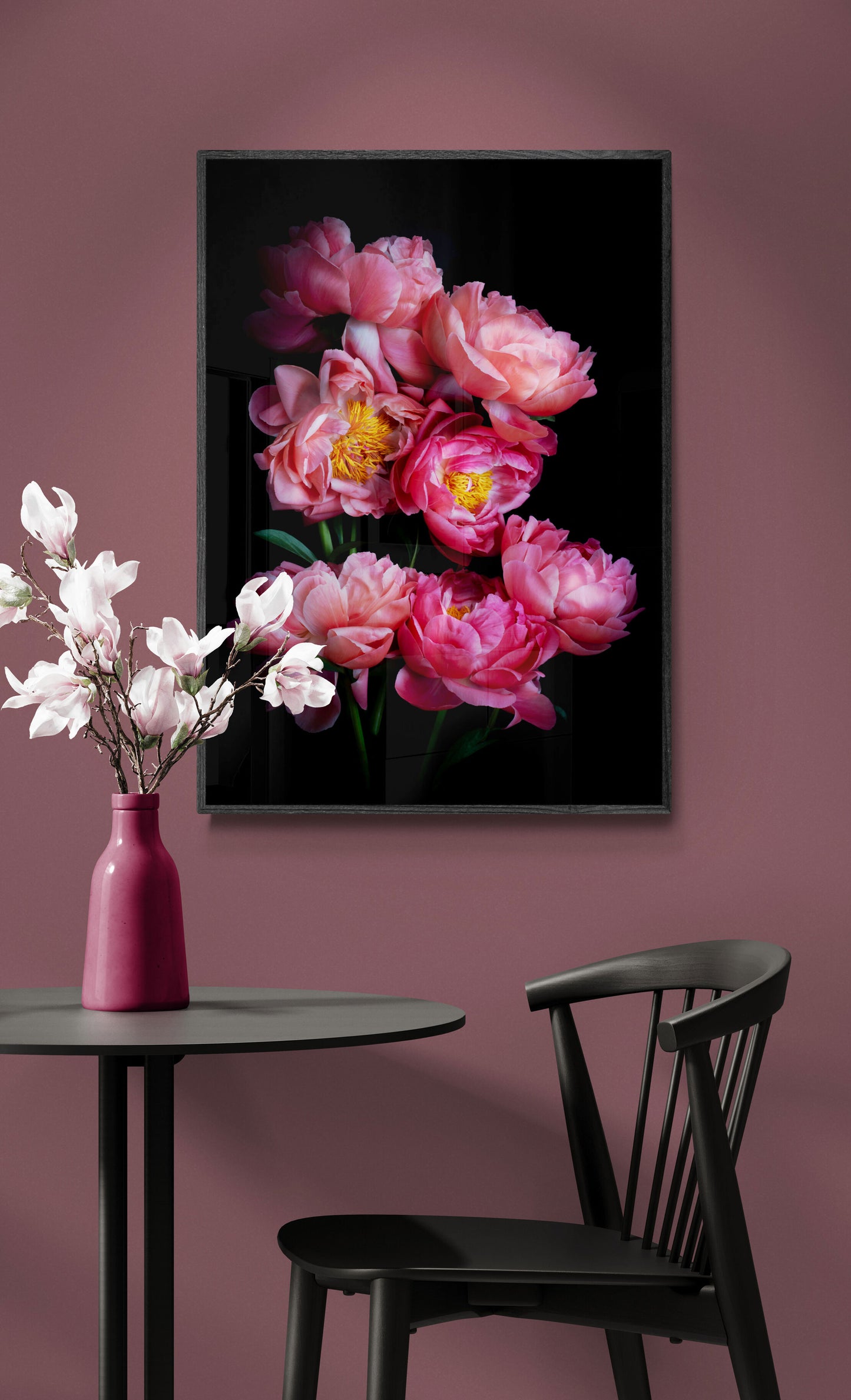Botanical print of 'Coral Sunset' Peonies framed and hung on a peach coloured wall.