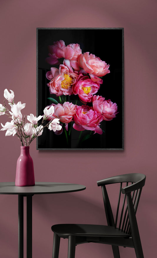 Botanical print of 'Coral Sunset' Peonies framed and hung on a peach coloured wall.