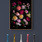 Framed dark botanical print of different coloured roses photographed on a black background hung on a gray coloured wall.